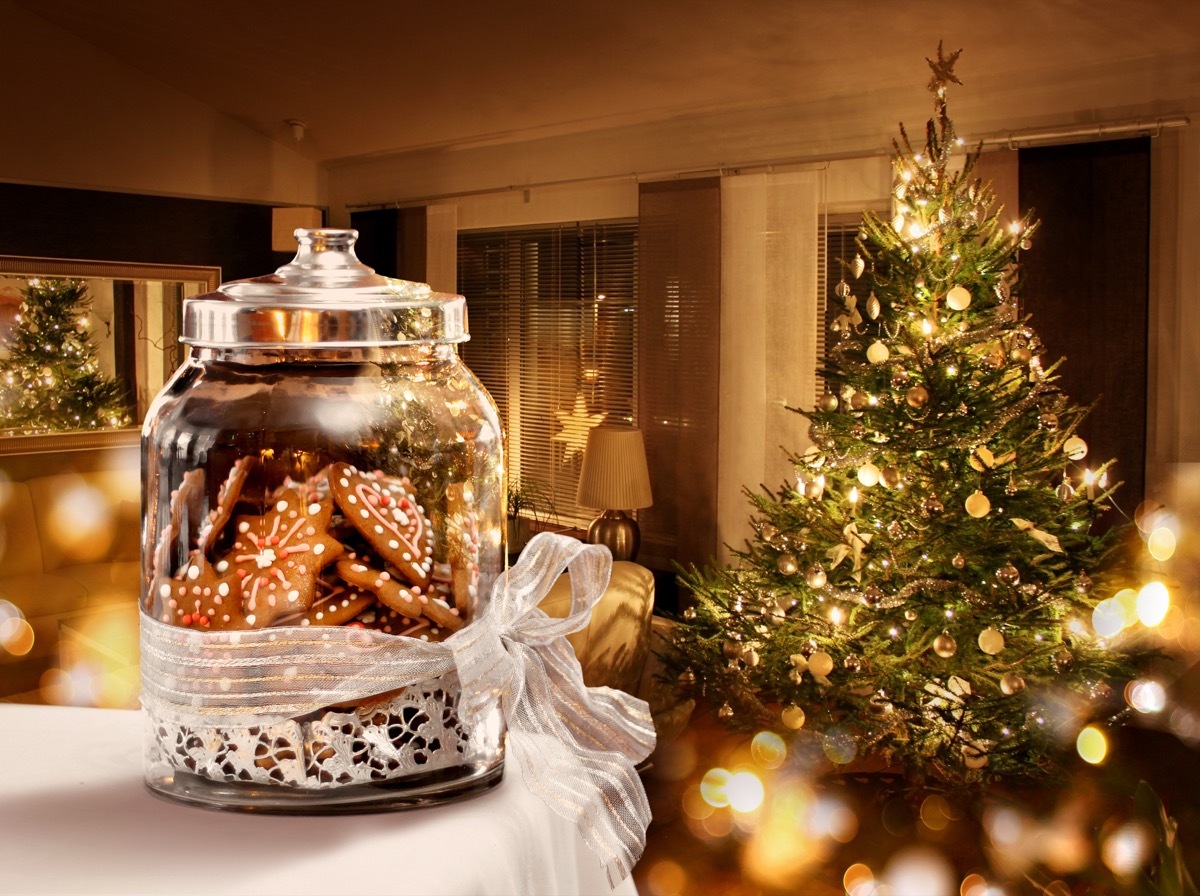 christmas tree in festive room with cookies in the foreground