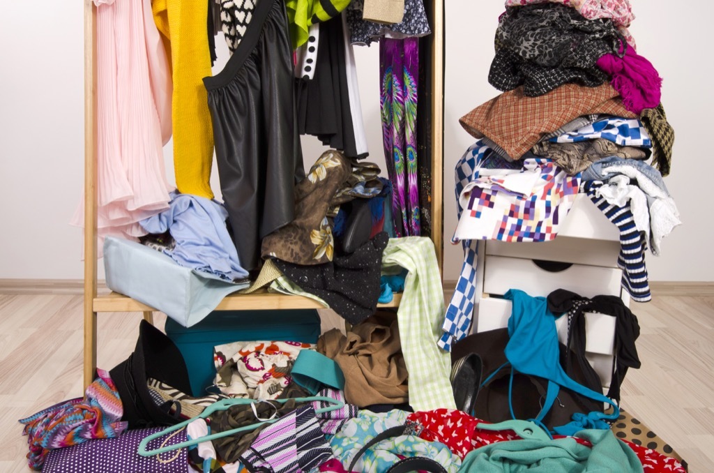 Messy closet with clothes strewn everywhere