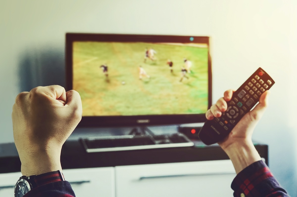 white guy watching soccer on tv