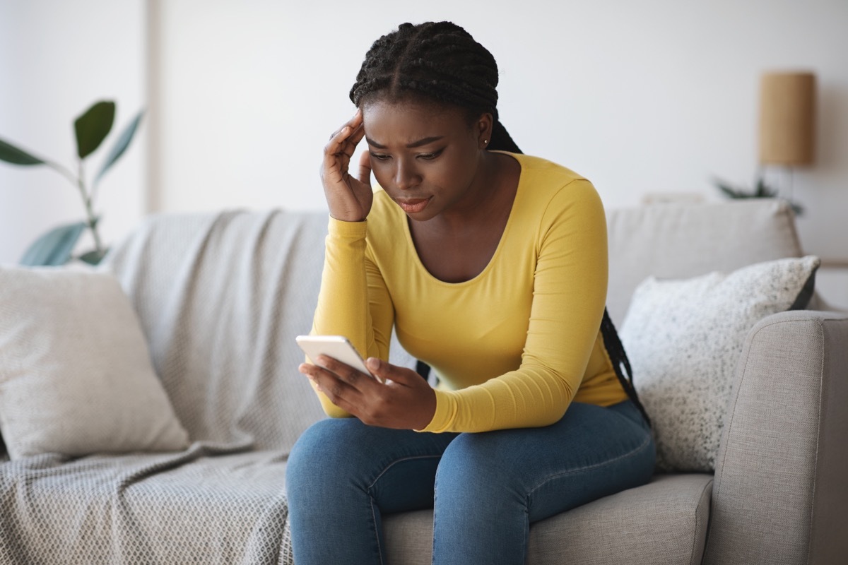 woman looking concerned at phone