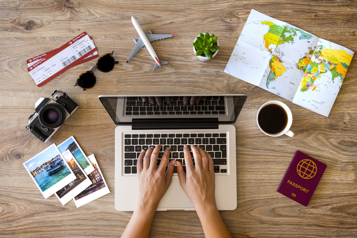 Woman using laptop and making a reservation for her travel.