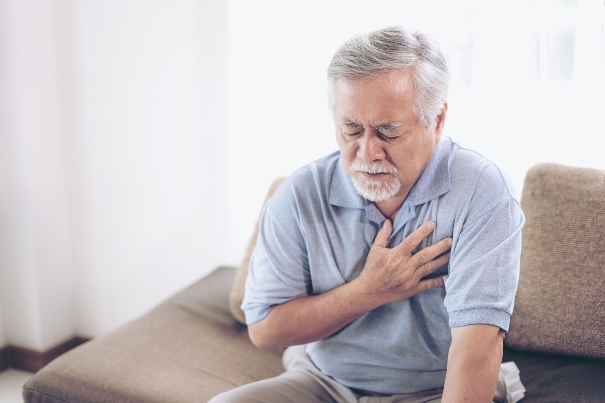 suffering from bad pain in his chest heart attack at home - senior heart disease