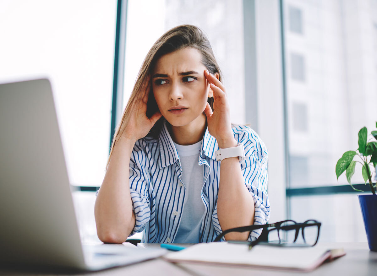 Woman is irritated and frustrated at work because of hormones