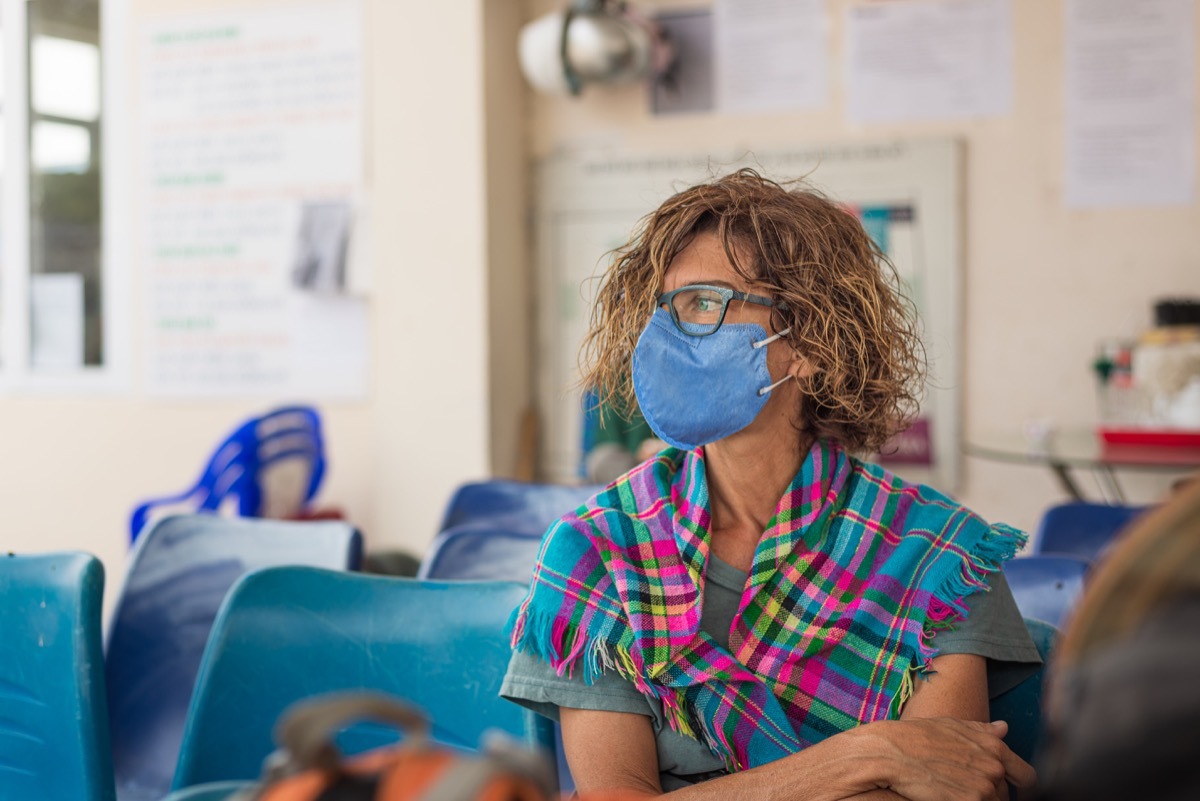 Woman wearing a mask in a doctor's waiting room