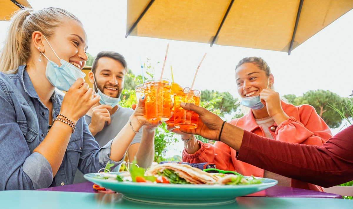 Young people wearing masks out for dinner and drinks