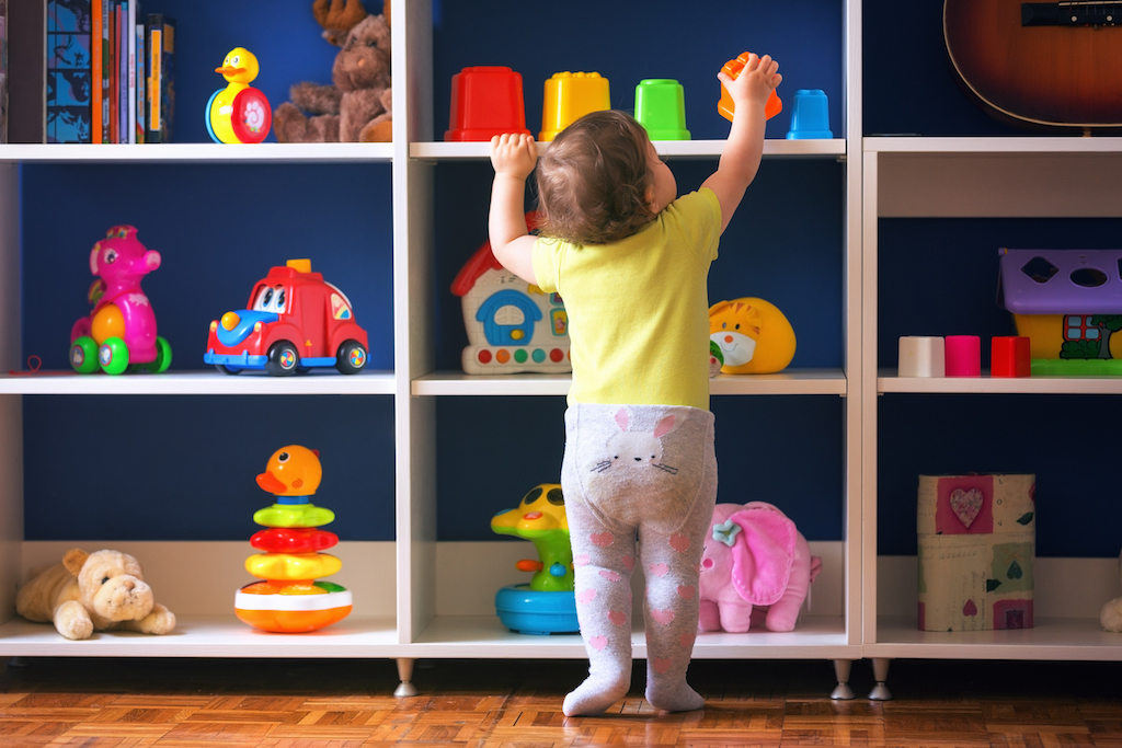 Child reaching for toy on shelf Tricks for hiding children's toys