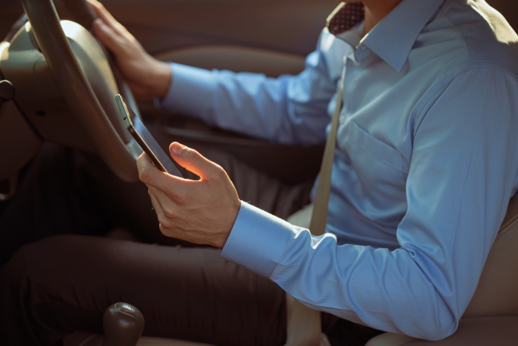 man texting while driving