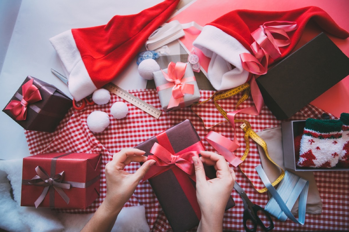 white hand wrapping christmas gifts