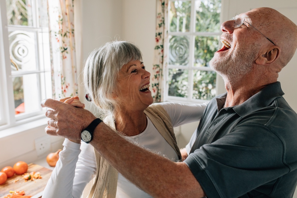 older couple dancing in their kitchen together